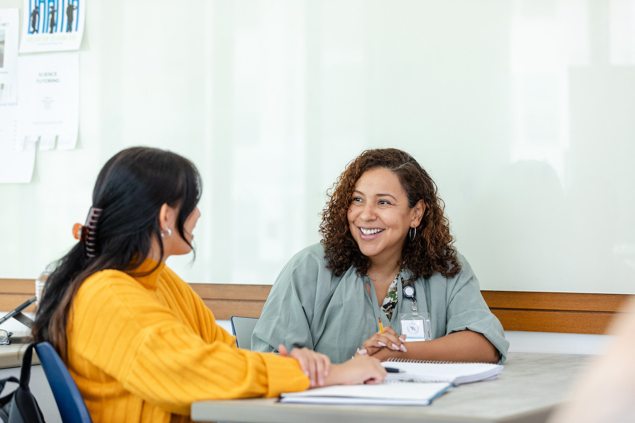 Mature teacher having conversation with young teacher